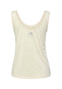 Ljuscremefärgad linne med en mjuk struktur, rund halsringning och subtil prickig mönstring. Kanterna är dekorerade med ljus persikofärgade detaljer.