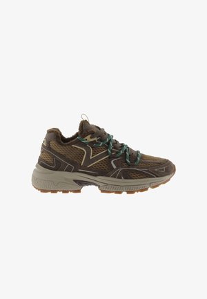 Zapatilla deportiva marrón y beige con paneles de malla, cordones verdes y marrones, y suela gruesa y texturizada.