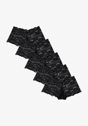 Culottes en dentelle noire avec un motif floral, présentant des bordures en forme de vagues et de petits accents en ruban. Quatre paires sont disposées à plat.