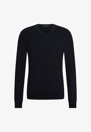 Maglione a maglia blu navy con polsini e orlo a coste, caratterizzato da una texture liscia e da una silhouette moderna, parzialmente mostrato con una mano in tasca.