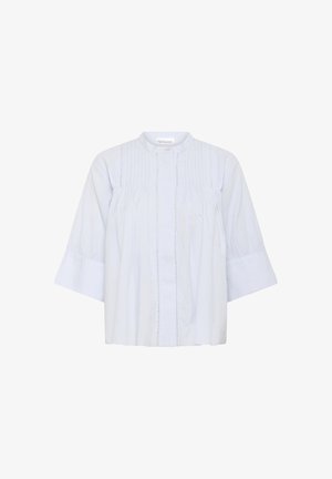 Hele helesinine, kerge särk ümmarguse kaelusega, nööbiga kinnitusega ja voltidega ees. Omab laiu, küünarvarre pikkuseid varrukaid ja tekstuurset kangast.