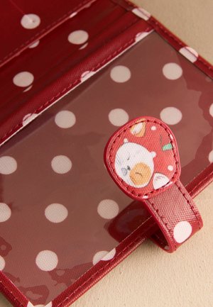 Red polka dot wallet or cardholder with a clear plastic ID window and a tab featuring a small cartoon bear face.