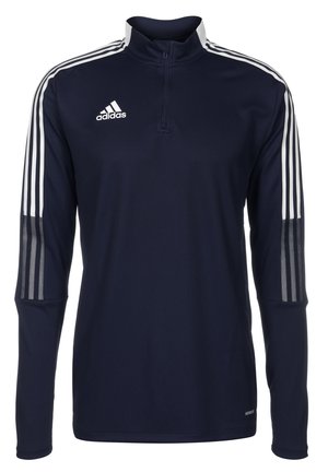 Marineblauwe Adidas sporttrui met lange mouwen, witte drie-strepen details op de mouwen, een korte rits bij de kraag en het Adidas-logo op de borst.
