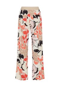 Pantalon ample avec une large ceinture beige et un grand motif floral orange, blanc, noir et rose sur fond beige.