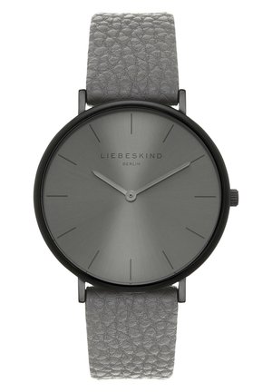 Minimalistisk gråt armbåndsur med tekstureret læderrem, sort urkasse, tynde timesmarkører og to simple visere, der viser 10:10.
