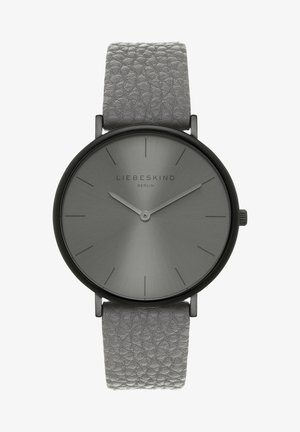 Montre-bracelet grise minimaliste avec un bracelet en cuir texturé, un boîtier noir, des index fins et deux aiguilles simples indiquant 10h10.