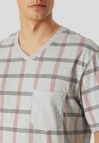 Gray v-neck T-shirt featuring a plaid pattern with red and black stripes, short sleeves, and a patch pocket on the left side.