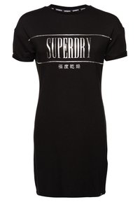 Robe t-shirt noire en coton, avec des manches courtes, un col rond et un imprimé graphique argenté "SUPERDRY" sur le devant.
