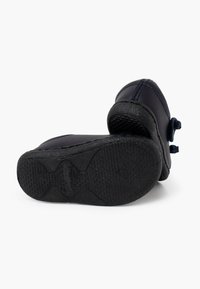 Stivale in pelle blu scuro con suola in gomma nera texturizzata. Presenta una punta arrotondata e un accento decorativo a fiocco sul lato.