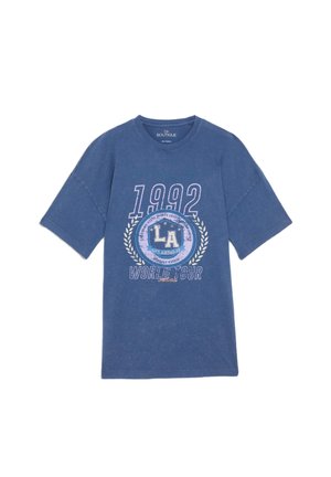 Blue graphic t-shirt, cotton material, relaxed fit. Features "1992" and "LA WORLD TOUR" print with laurel accents. Short sleeves and crew neck.