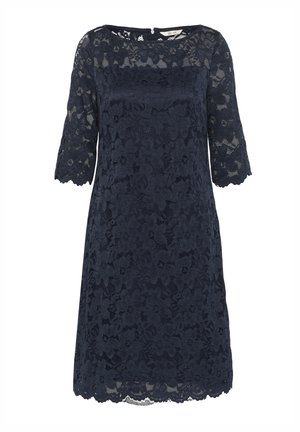 Robe en dentelle bleu marine avec des manches courtes, motif floral, ourlet festonné et coupe droite, dotée d'une fermeture éclair dans le dos.