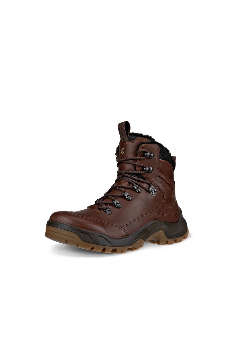 Scarpa da trekking in pelle marrone con lacci neri, colletto imbottito e suola in gomma testurizzata. Presenta occhielli metallici e rinforzo sulla punta.