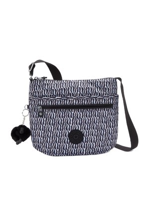 Petit sac bandoulière avec motif ondulé noir et blanc, poche avant zippée, bandoulière noire réglable et porte-clés en peluche noire attaché.