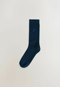 Navy blue ankle sock made of a textured material; features a ribbed cuff and a subtle logo design near the top.
