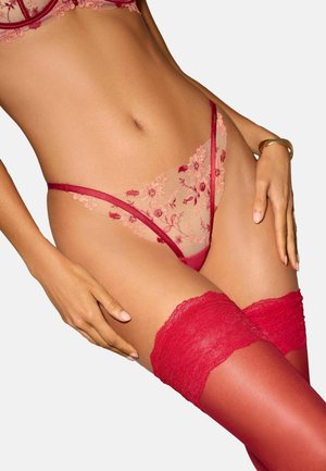 Red lace lingerie set featuring floral embroidery and sheer mesh material, accompanied by matching red thigh-high stockings with lace trim.
