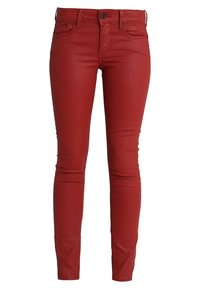 Vaqueros skinny rojos con una textura suave, diseño de cinco bolsillos y cierre de botones. Presentan una silueta ajustada y detalles de costura en contraste.
