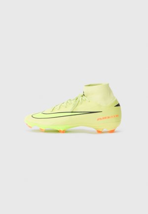Nike soccer cleat in bright yellow with black accents, high-top design, textured upper, and orange studs on the sole. "AIR ZOOM" on the heel.
