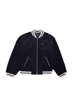 Navy blue corduroy bomber jacket with white striped collar, cuffs, and hem, zip closure, angled pockets, and small orange embroidery on chest.