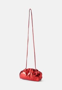 Red metallic shoulder bag with gathered texture, slim adjustable strap, curved shape, and smooth, reflective finish.