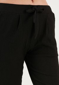 LELA SLIM FIT - Trousers - black