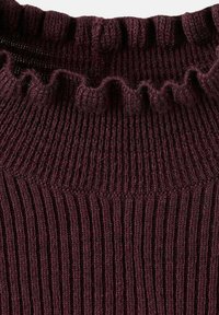 Détail d'un pull en maille bourgogne présentant une texture côtelée et un col à volants, mettant en valeur un tissu doux et chaud avec des lignes verticales.