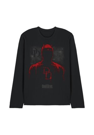 Black long-sleeve shirt with a red silhouette of Daredevil and the "DD" logo over a gray brick wall background.