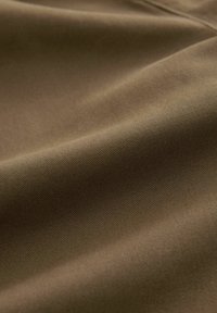 Cotton blend fabric in a muted olive green color, features a smooth, slightly textured surface with subtle diagonal lines.