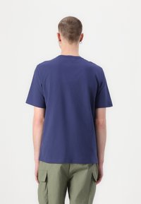 Navy blue crew neck t-shirt with short sleeves, made of soft fabric, featuring a plain design and a relaxed fit. Back view shows no patterns.