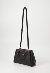 Black handbag with a structured design, textured surface, dual handles, and an adjustable shoulder strap. Features a zipper and gold accents.