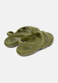 Green rubber sandals with three broad straps and textured footbed. Lightweight design with contoured sole for comfort.