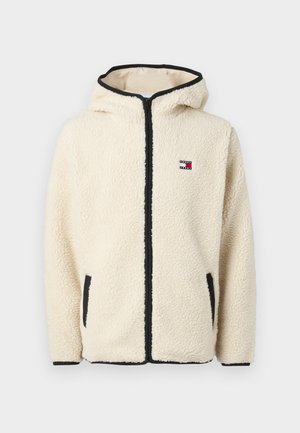 Kremfarvet sherpa fleece jakke med lynlås og hætte, sort kant, to forlommer og lille Tommy Jeans logo på brystet.