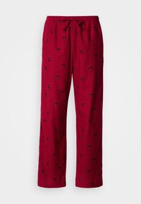 Pantalon de pyjama rouge avec une taille à cordon, présentant un motif subtil de petites formes noires partout. Fabriqué en tissu doux et léger.