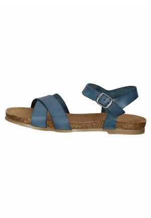 Niebieskie skórzane płaskie sandały z korkową wkładką, dwoma krzyżującymi się paskami z przodu, paskiem na kostkę z srebrną klamrą i jasnobrązową gumową podeszwą.