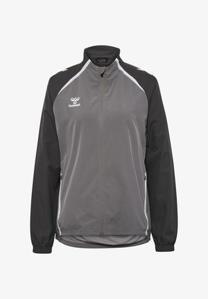 Grijze en zwarte zip-up jas met een staande kraag, lange mouwen en een gladde textuur. Bevat witte accenten en het Hummel-logo op de borst.