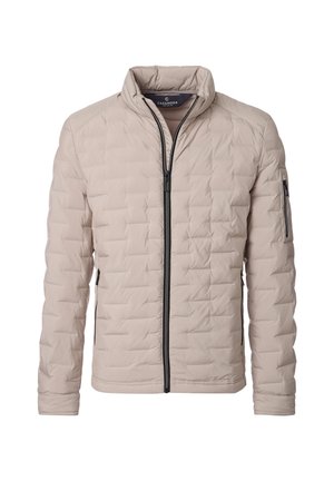 Vaaleanbeige tikattu takki, jossa on musta täysvetoketju, pystykkaulus, kaksi sivuvetoketjullista taskua ja vetoketjutasku vasemman hiha.