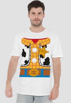 White t-shirt featuring a printed graphic of a cowboy shirt, with a yellow checkered pattern, cow spots, buttons, and a sheriff badge.