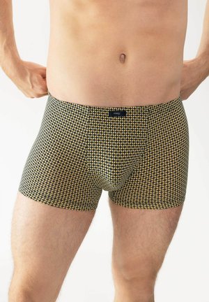 Zwarte en gele gestreepte boxershorts van elastische stof, met een aansluitend ontwerp en een logo-label op de tailleband.