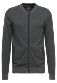 Cardigan grigio scuro con zip, caratterizzato da una texture liscia, polsini e orlo a costine, e tasche laterali con un design minimalista.