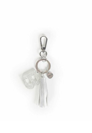 Portachiavi con hardware in argento, abbellimento glitterato traslucido, nappina in finta pelle bianca e anello circolare con un charm decorativo.