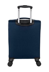 Maleta azul marino con asa retráctil, carcasa dura y cuatro ruedas negras para facilitar la movilidad. Textura suave y diseño minimalista.