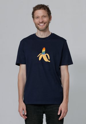 Navy blue cotton t-shirt featuring a graphic of a banana with a colorful striped peel design. Short sleeves and crew neckline.