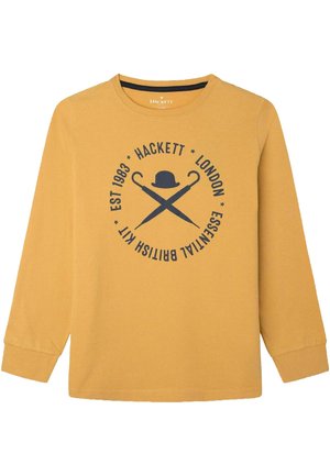 Langärmliges, senfgelbes Baumwoll-T-Shirt mit einem marineblauen Kreisgrafik-Design, das gekreuzte Zuckerstangen und einen Bowlerhut zeigt, Markenname und Gründungsjahr.