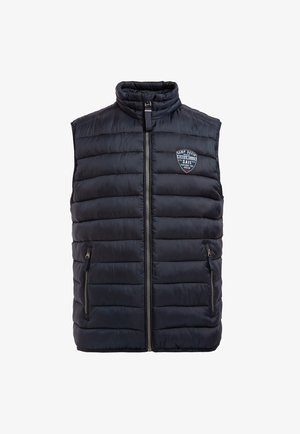 Marineblaues Puffer-Westen mit hohem Kragen, Reißverschluss und zwei Seitentaschen. Mit horizontalen Nähten und Emblem auf der linken Brust.