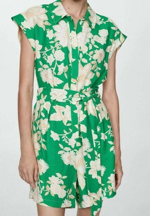 Grøn blomsterkjole med korte ærmer, en krave og en knyttet talje. Stoffet har en glat tekstur med store cremefarvede blomster.