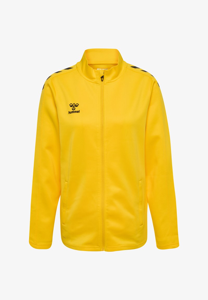 Gul zip-up jacka i slät tyg, med hög krage, sidofickor och svarta detaljer på axlarna. Hummel-logotyp på bröstet.