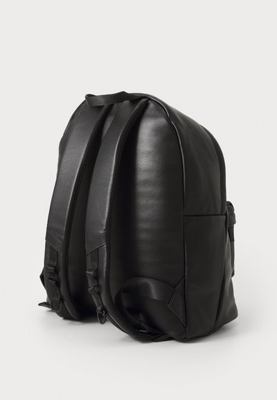 Black leather backpack with a smooth texture, rounded shape, padded straps, and side hardware. Features dual adjustable straps on top.