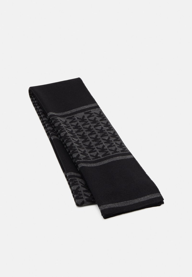 Écharpe tricotée noire et gris foncé avec un motif géométrique plié et des rayures horizontales sur un fond clair uni.