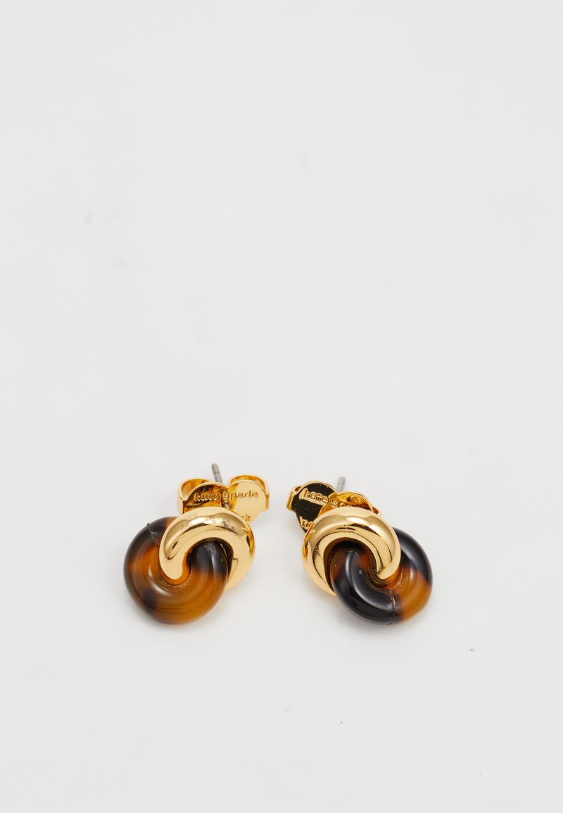 Gold-tone stud earrings with intertwined tortoiseshell and metallic loops on a white background.