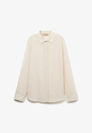 Beiges Langarm-Hemd mit Knöpfen, spitzem Kragen und verdeckten Knöpfen, auf weißem Hintergrund dargestellt.