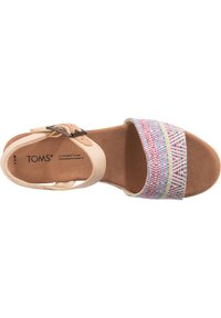 Tan fabric sandal with a colorful woven strap featuring geometric patterns. Includes an adjustable buckle and a cushioned footbed.